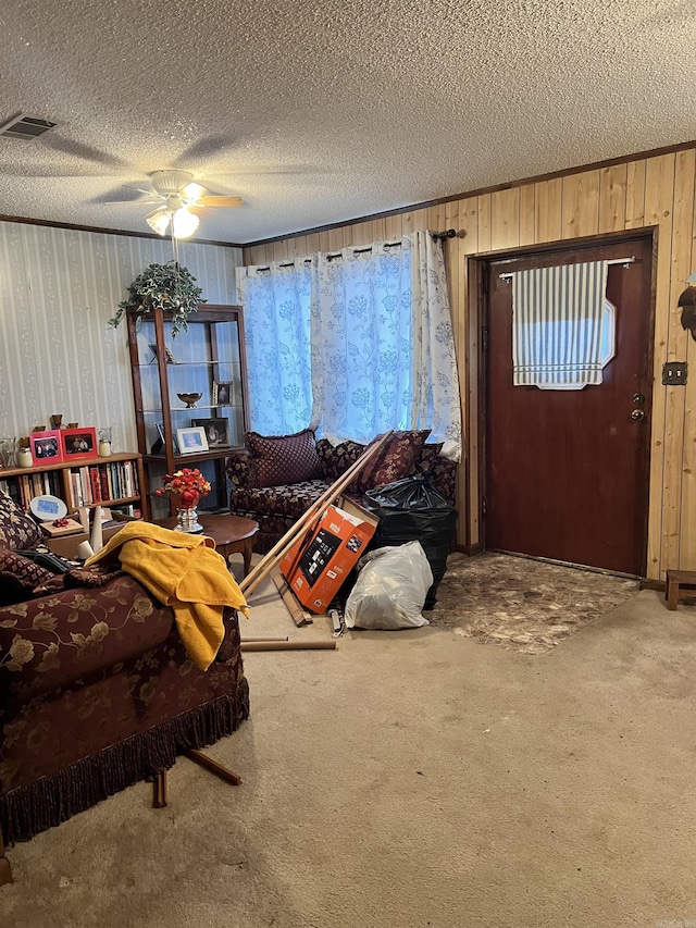 living room with carpet flooring, ceiling fan, and a textured ceiling