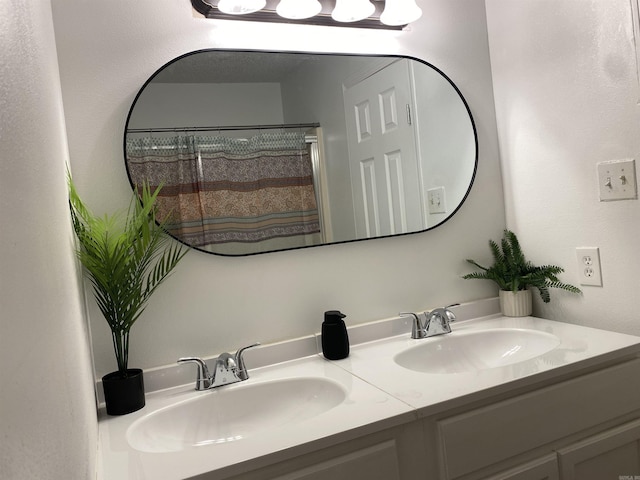 bathroom featuring a shower with curtain and vanity