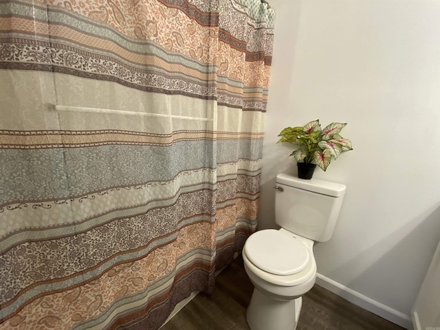 bathroom with toilet and hardwood / wood-style flooring