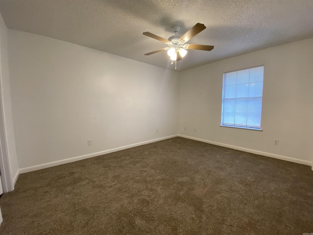 carpeted empty room with ceiling fan and a textured ceiling