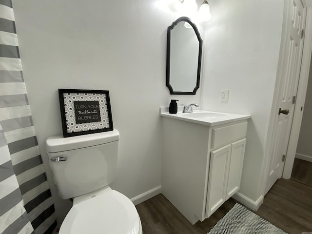 bathroom featuring vanity, wood-type flooring, and toilet