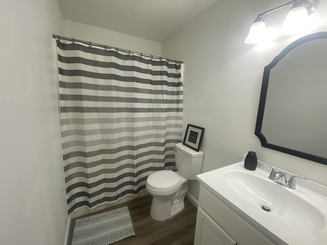 bathroom with wood-type flooring, a textured ceiling, toilet, vanity, and a shower with shower curtain