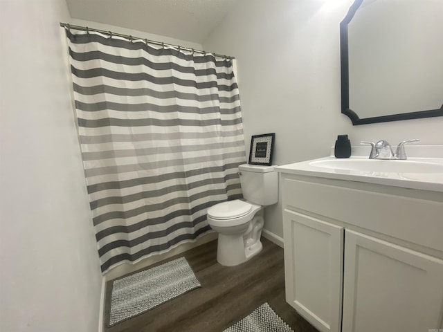 bathroom featuring vanity, toilet, and wood-type flooring