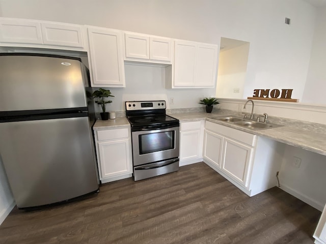 kitchen featuring white cabinets, sink, stainless steel appliances, and dark wood-type flooring