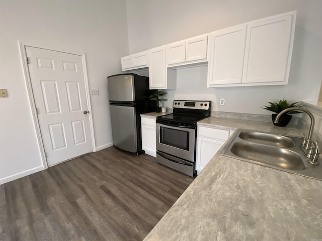 kitchen featuring stainless steel appliances, white cabinetry, dark wood-type flooring, and sink