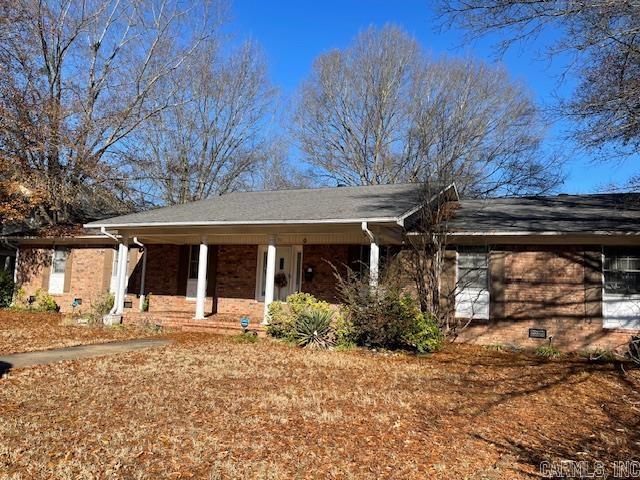 single story home featuring covered porch