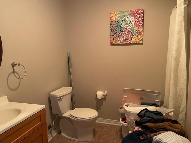 bathroom featuring tile patterned floors, toilet, and vanity