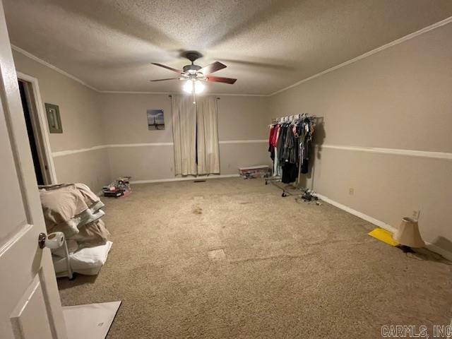 unfurnished bedroom with crown molding, carpet flooring, a textured ceiling, and ceiling fan