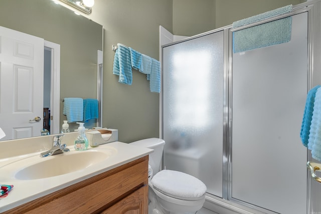 bathroom featuring vanity, toilet, and walk in shower