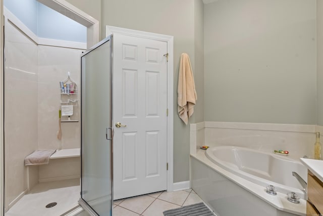 bathroom with tile patterned flooring, vanity, and shower with separate bathtub