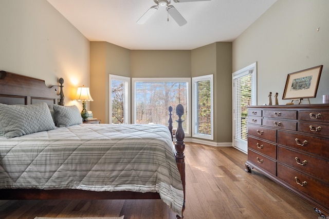 bedroom featuring access to exterior, light hardwood / wood-style flooring, and ceiling fan