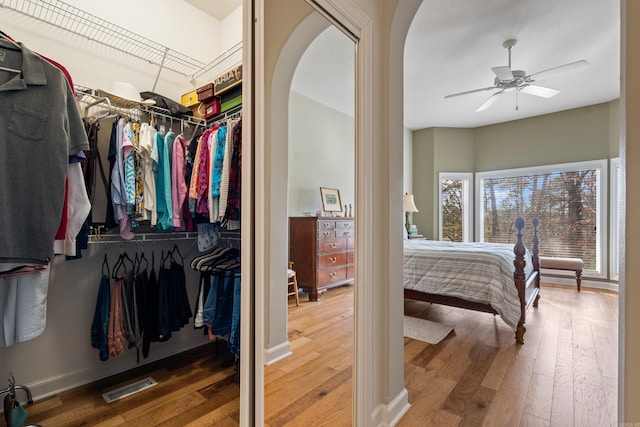 bedroom with ceiling fan, a closet, and hardwood / wood-style flooring