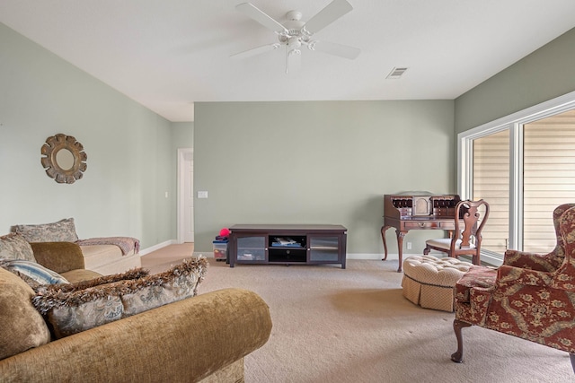 carpeted living room with ceiling fan