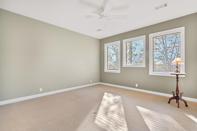 unfurnished room featuring ceiling fan and light colored carpet