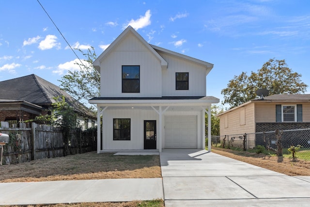 modern farmhouse featuring covered porch and a garage