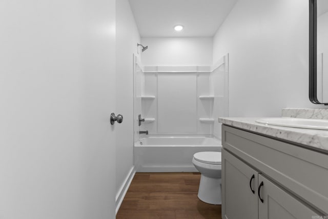 full bathroom with hardwood / wood-style floors, toilet, shower / bathtub combination, and vanity