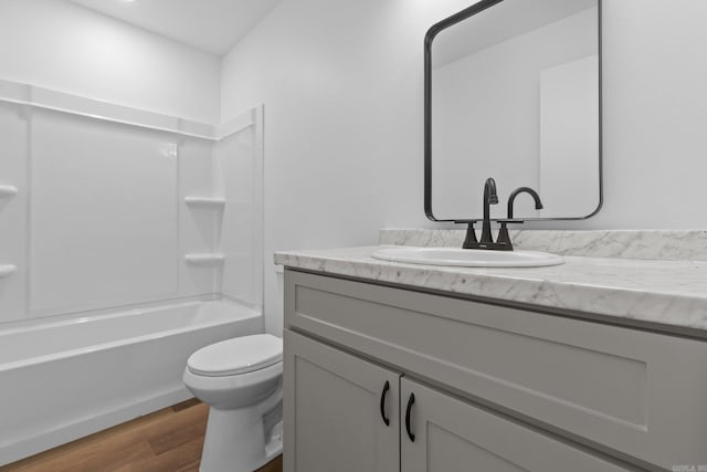 full bathroom featuring toilet, vanity, hardwood / wood-style floors, and shower / bath combination