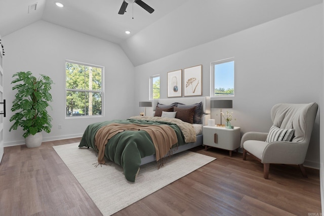 bedroom with ceiling fan, hardwood / wood-style floors, and vaulted ceiling