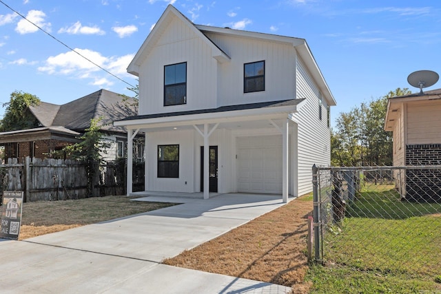 modern inspired farmhouse featuring a front yard, a garage, and a porch