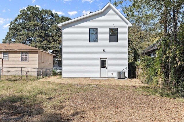 back of house with central AC unit