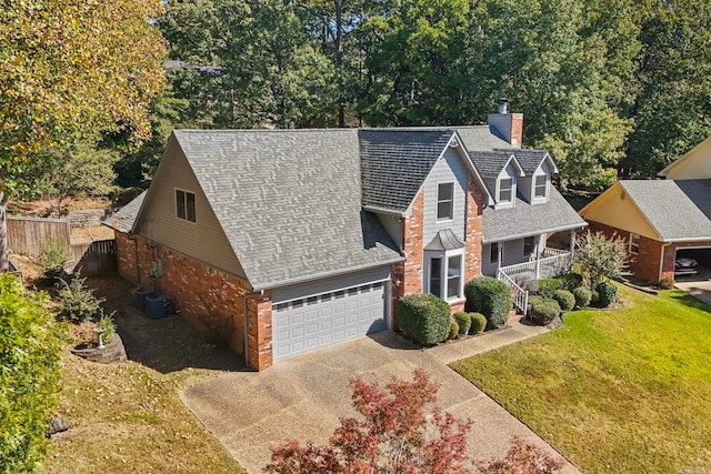 view of front of home with covered porch, a front yard, and a garage