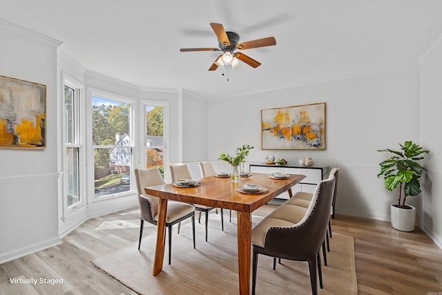 dining space with hardwood / wood-style floors, ceiling fan, and crown molding