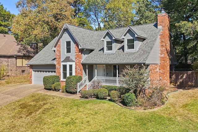 view of front of house with a porch, a garage, and a front lawn