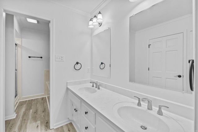 bathroom with crown molding, vanity, wood-type flooring, and a shower with shower door