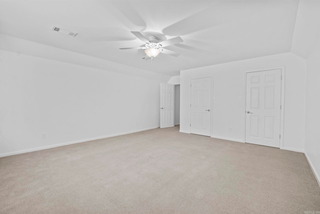 unfurnished bedroom with light carpet, vaulted ceiling, and ceiling fan