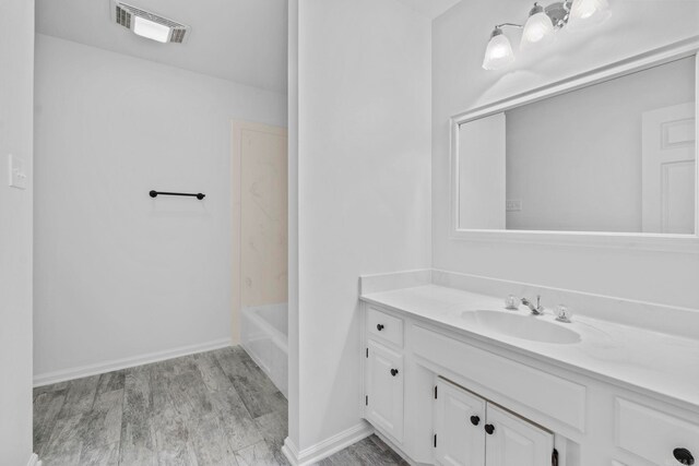 bathroom with vanity, wood-type flooring, and bathing tub / shower combination