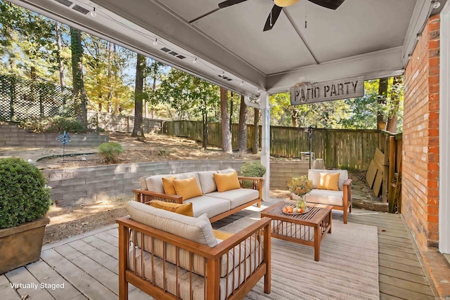 view of patio featuring outdoor lounge area, ceiling fan, and a deck