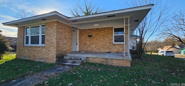 view of exterior entry featuring a yard