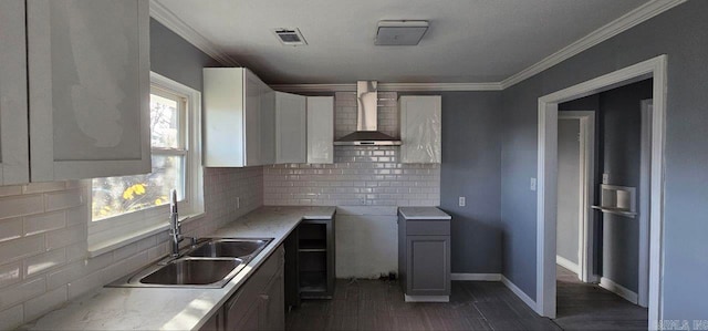 kitchen with backsplash, ornamental molding, wall chimney exhaust hood, dark wood-type flooring, and sink