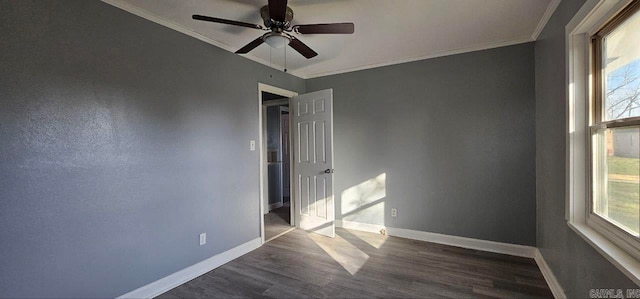 unfurnished room featuring crown molding, ceiling fan, and dark wood-type flooring