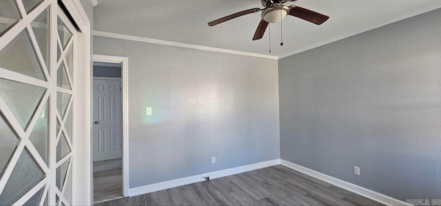 spare room featuring ceiling fan, dark wood-type flooring, and ornamental molding