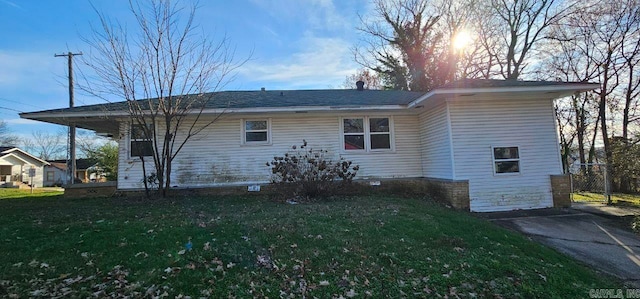 rear view of house featuring a yard