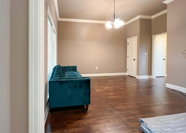 living area with a chandelier, crown molding, and dark wood-type flooring