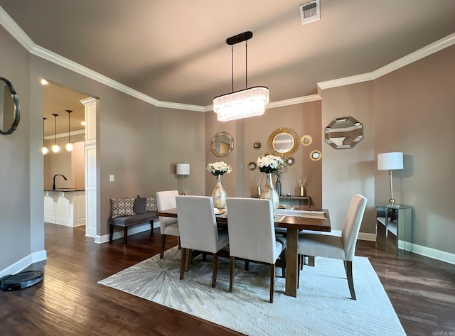 dining room featuring crown molding and dark wood-type flooring