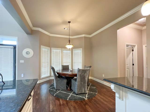 dining area featuring dark wood-type flooring and ornamental molding