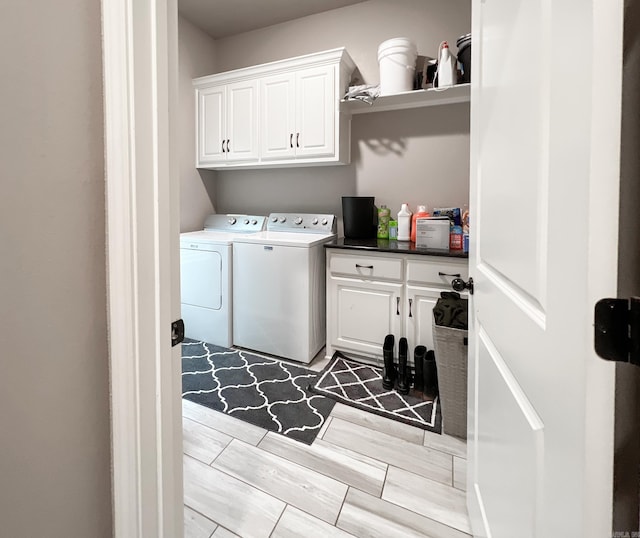 washroom featuring cabinets and separate washer and dryer