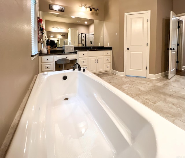 bathroom with a bathing tub and vanity