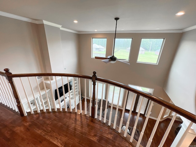 staircase with hardwood / wood-style flooring, crown molding, and a wealth of natural light