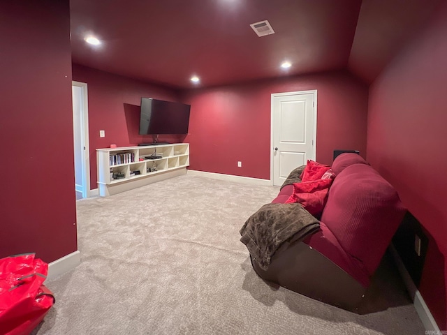 cinema featuring carpet and vaulted ceiling