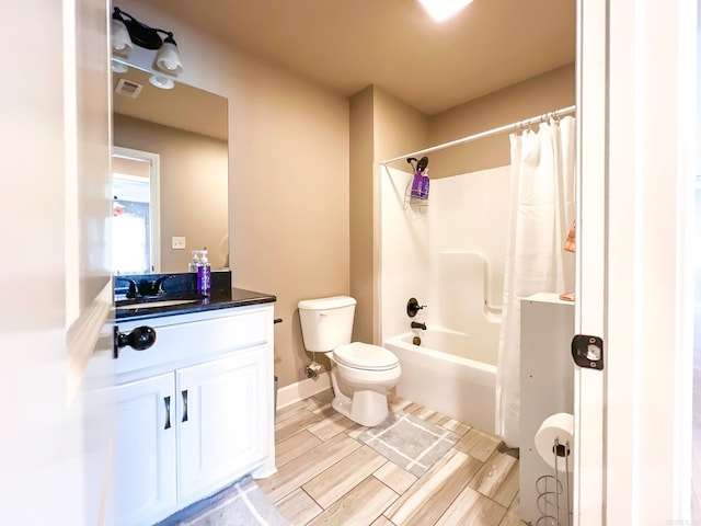 full bathroom featuring shower / bath combo, toilet, and vanity