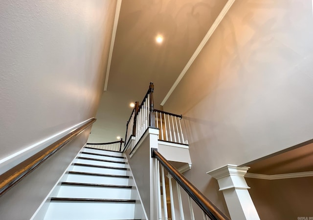 stairway featuring crown molding