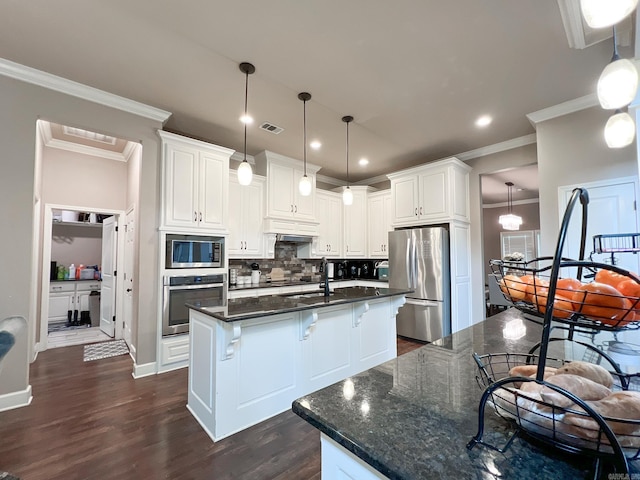 kitchen with white cabinetry, a center island with sink, decorative light fixtures, and appliances with stainless steel finishes