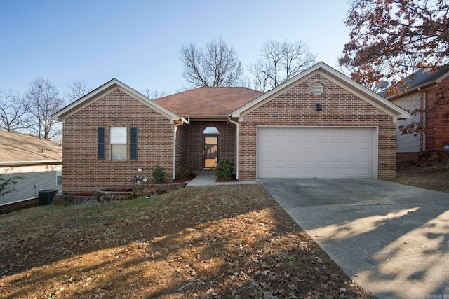 ranch-style home with a garage and central AC unit