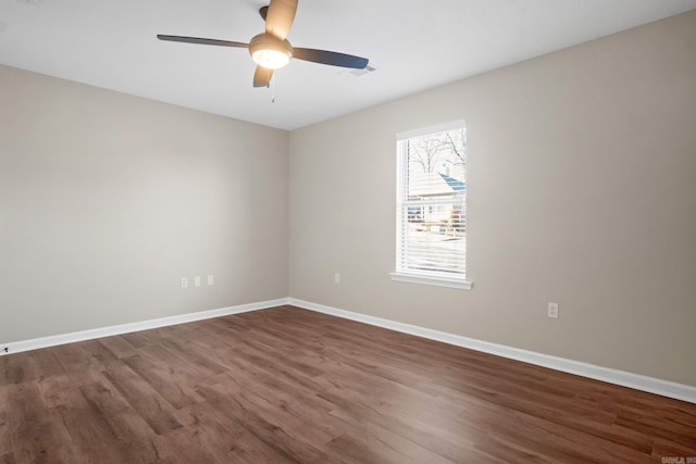 spare room featuring dark hardwood / wood-style floors and ceiling fan