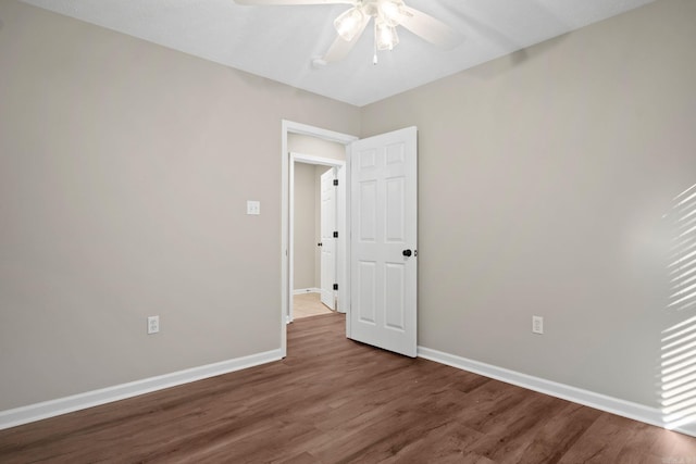 unfurnished bedroom featuring ceiling fan and dark wood-type flooring