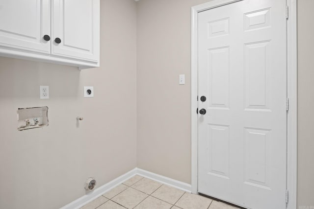 laundry area featuring electric dryer hookup, cabinets, hookup for a gas dryer, washer hookup, and light tile patterned floors